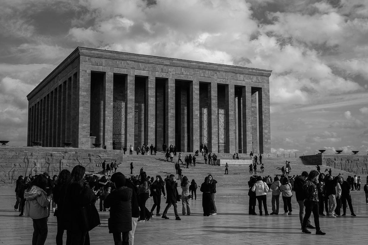 Black and white photo of Anıtkabir with a crowd of visitors in Ankara, Turkey.