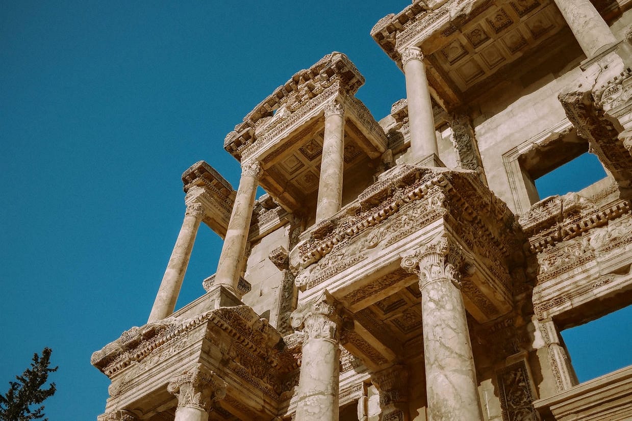 Detailed view of the historic Ephesus Library's Roman architecture under a clear blue sky.