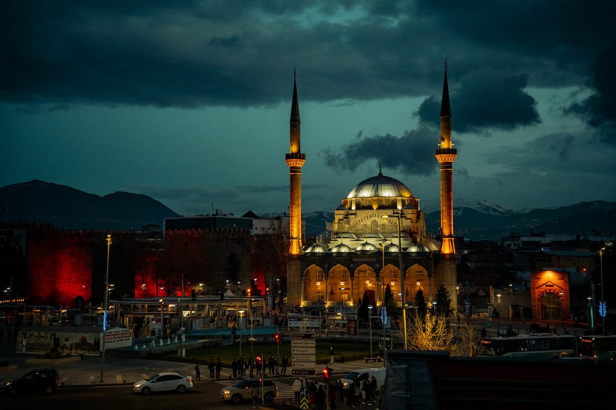 Illuminated Erciyes University Mosque at night in Kayseri, Turkey, showcasing stunning architecture.
