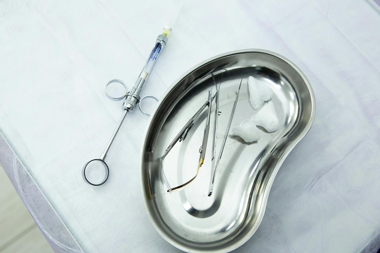 A set of sterile medical tools and syringe displayed in a kidney tray for dental or surgery. Turkey Travel Health Guide.